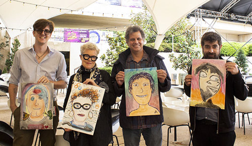 QPAC staff holding their Here I Am portraits