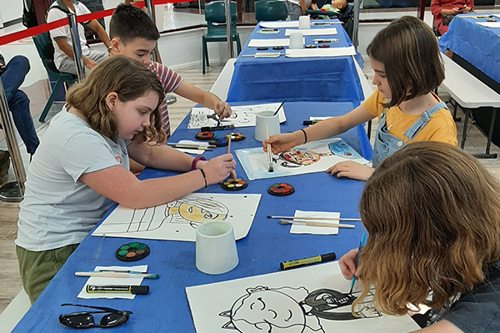 Children show off their artistic skill as they paint